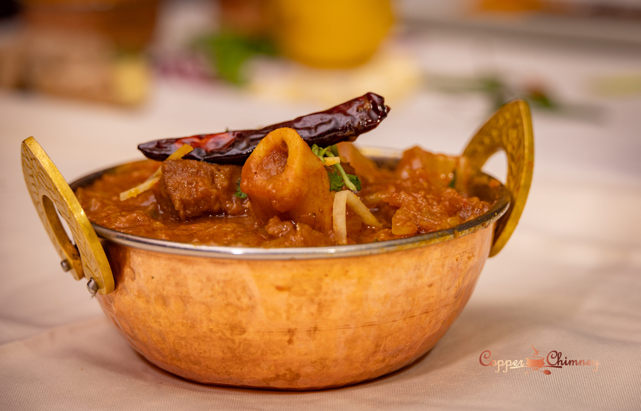 Dal makhani scooped with fresh tandoor naan at Copper Chimney Winnipeg
